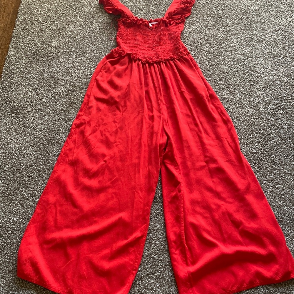 Red romper with tank sleeves.